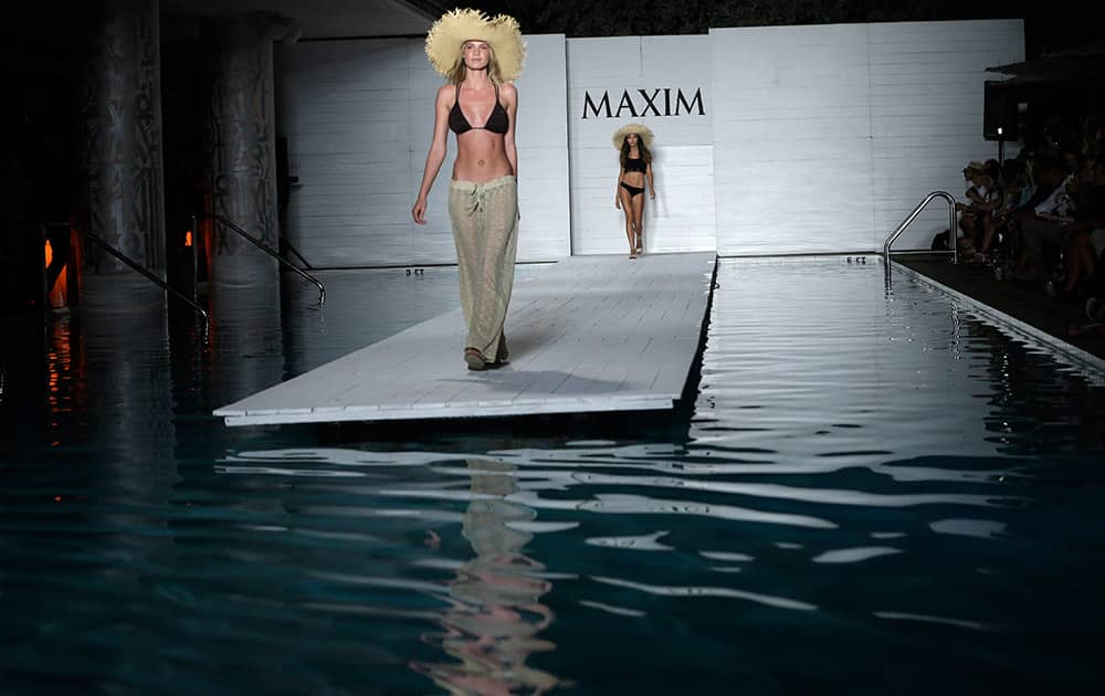 A model walks down the runway during the Maxim Swimwear collection launch as part of Funkshion Fashion Week Swim in Miami Beach, Fla.