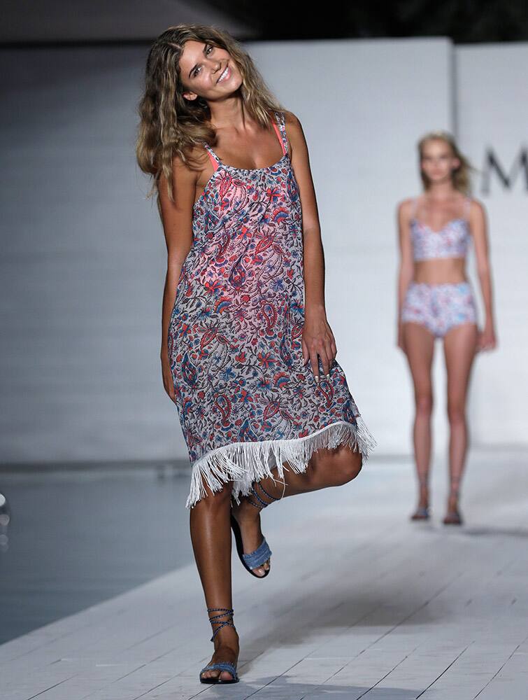 A model walks down the runway during the Maxim Swimwear collection launch as part of Funkshion Fashion Week Swim in Miami Beach, Fla.