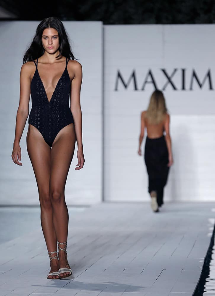 A model walks down the runway during the Maxim Swimwear collection launch as part of Funkshion Fashion Week Swim in Miami Beach, Fla.