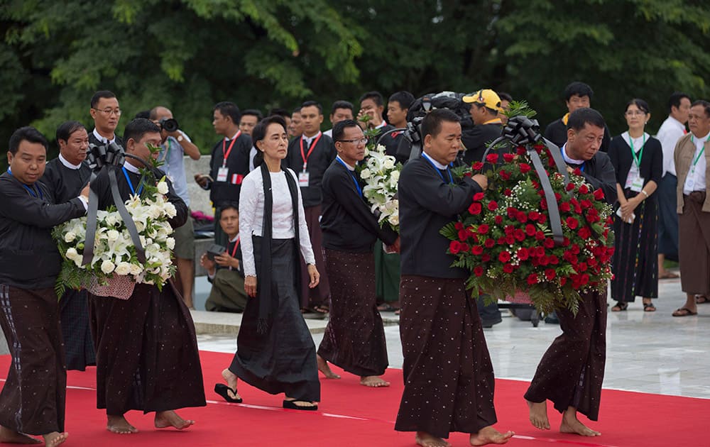 Myanmar opposition leader Aung San Suu Kyi arrives to pay respect at the tomb of her late father and Myanmar's Independence hero Gen. Aung San during a ceremony to mark the 68th anniversary of his 1947 assassination, at the Martyrs' Mausoleum in Yangon, Myanmar.