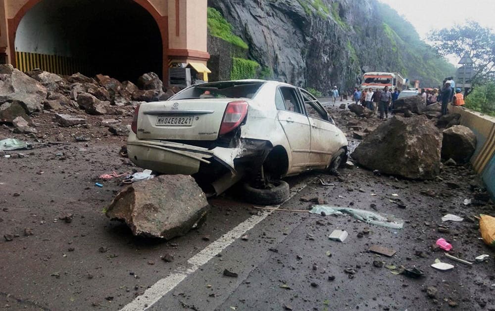 A damaged car outside the Adhoshi tunnel near Pune on Pune-Mumbai expressway after a major landslide.