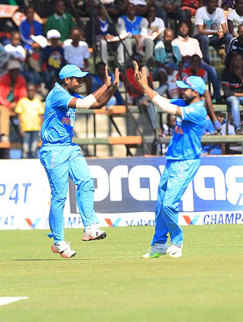 Indian cricket players celebrate the wicket of Zimbabwean batsman Vusimusi Sibanada during their Twenty20 cricket match in Harare, Zimbabwe.