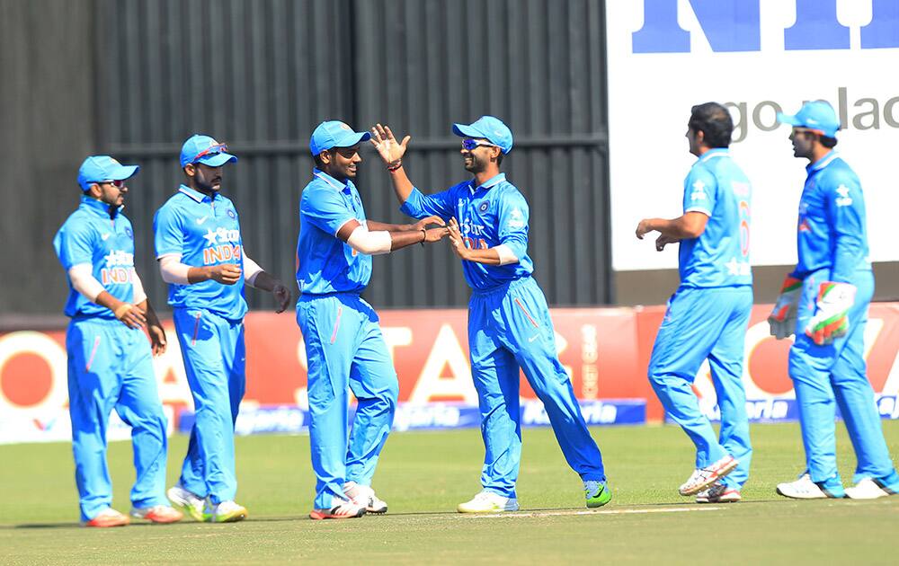 Indian cricket players celebrate the wicket of Zimbabwean batsman Vusimusi Sibanada during their Twenty20 cricket match in Harare, Zimbabwe.