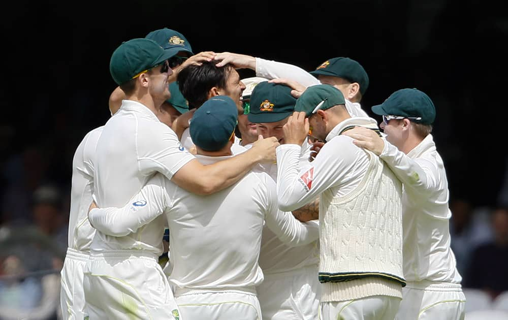 Australia's Mitchell Johnson is congratulated on taking the wicket of England's Alastair Cook on the fourth day of the second Ashes Test match between England and Australia, at Lord's cricket ground in London.