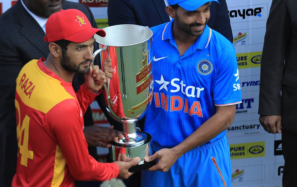 Zimbabwean captain Sikandar Raza and Indian captain Ajiknya Rahane share the trophy after Zimbabwe levelled the series of their Twenty20 cricket series in Harare, Zimbabwe.