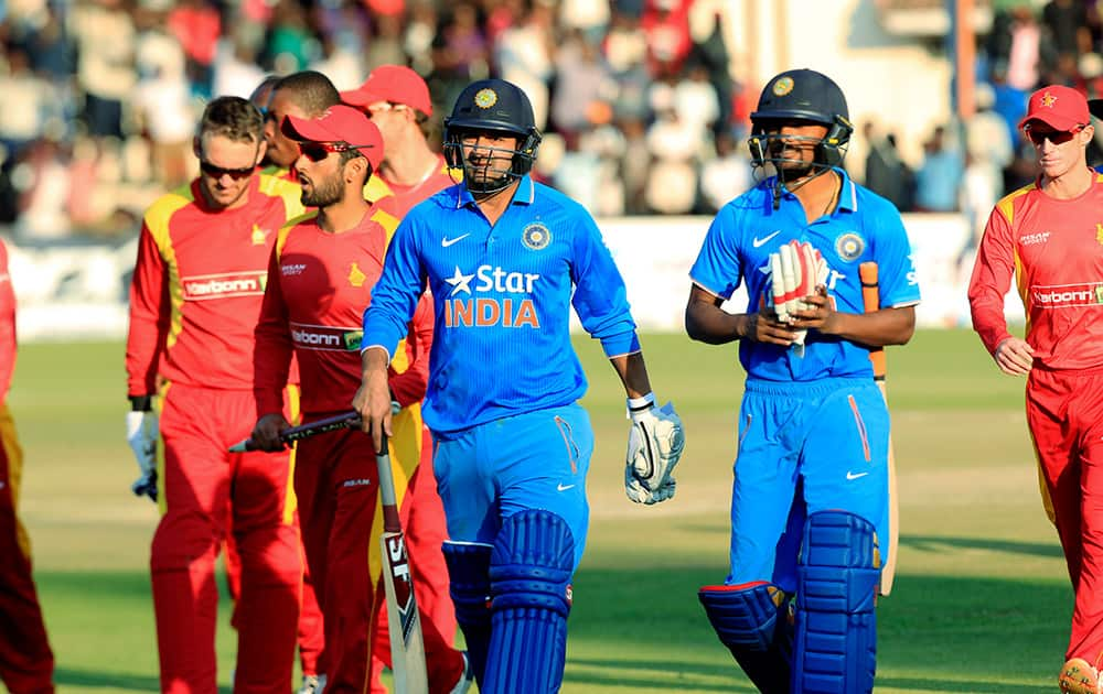 Indian batsman walk off the pitch after losing to Zimbabwe in their Twenty20 cricket match in Harare, Zimbabwe.