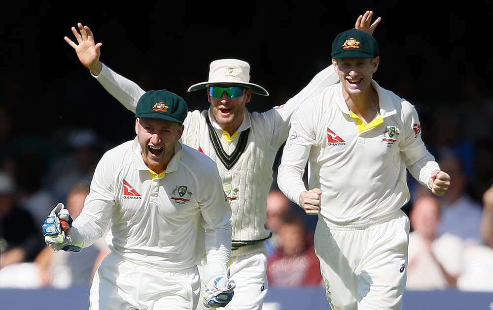 Australia's Peter Nevill, Michael Clarke and Adam Voges celebrate taking the wicket of wicketkeeper Jos Buttler on the fourth day of the second Ashes Test match between England and Australia, at Lord's cricket ground in London.