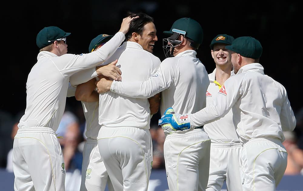 Australia's players celebrate taking the wicket of England's Jos Buttler on the fourth day of the second Ashes Test match between England and Australia, at Lord's cricket ground in London.