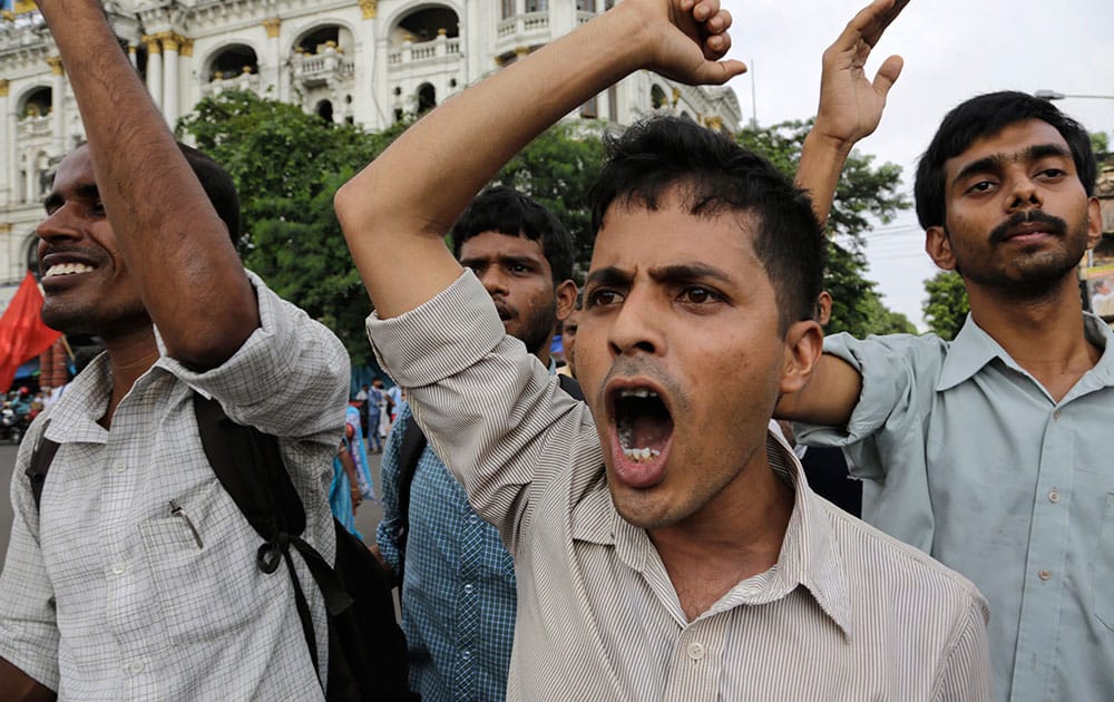 Left party activists shout slogans as they walk in a rally protesting the proposed land bill by India’s ruling Bharatiya Janata Party government and also demanding proper investigation into various corruption scandals in Kolkata, India.