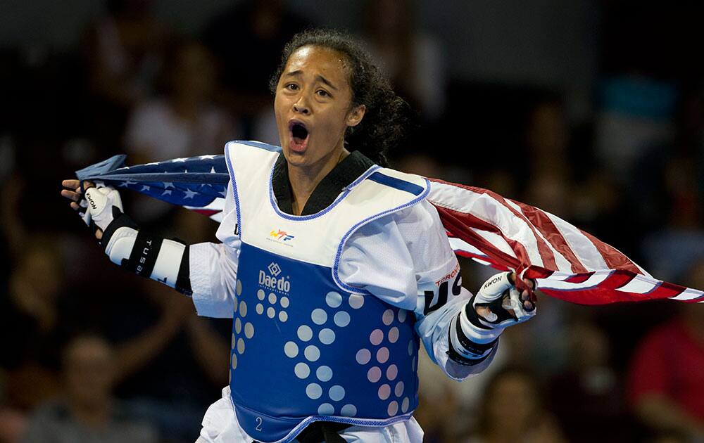 Cheyenne Lewis of the U.S. celebrates after winning gold in the women's taekwondo under-57kg category, at the Pan Am Games in Mississauga, Ontario.