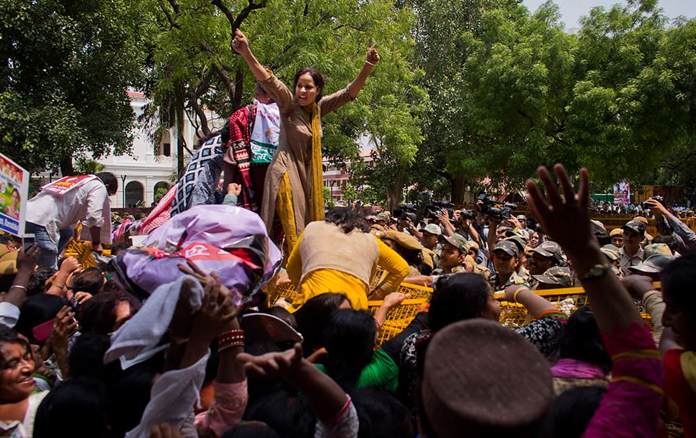 Congress party supporters climb a barricade during a protest against Prime Minister Narendra Modi in New Delhi.