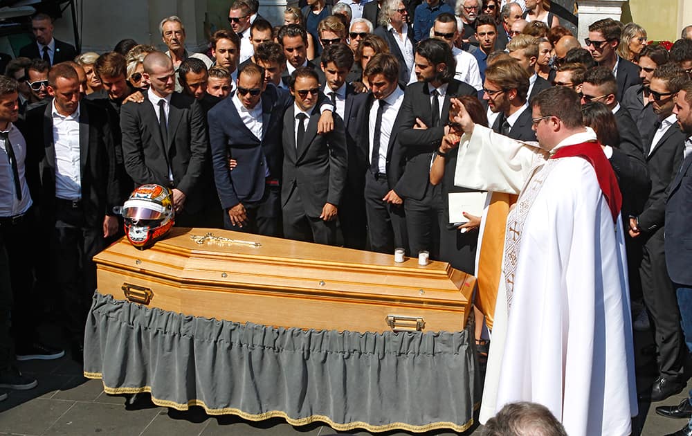 Priest Sylvain Brison, right, blesses the casket of French Formula One driver Jules Bianchi into Sainte Reparate Cathedral during his funeral in Nice, French Riviera.