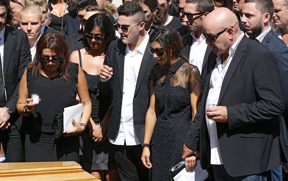 Parents of French Formula One driver Jules Bianchi stand near his casket at Sainte Reparate Cathedral during his funeral in Nice, French Riviera.