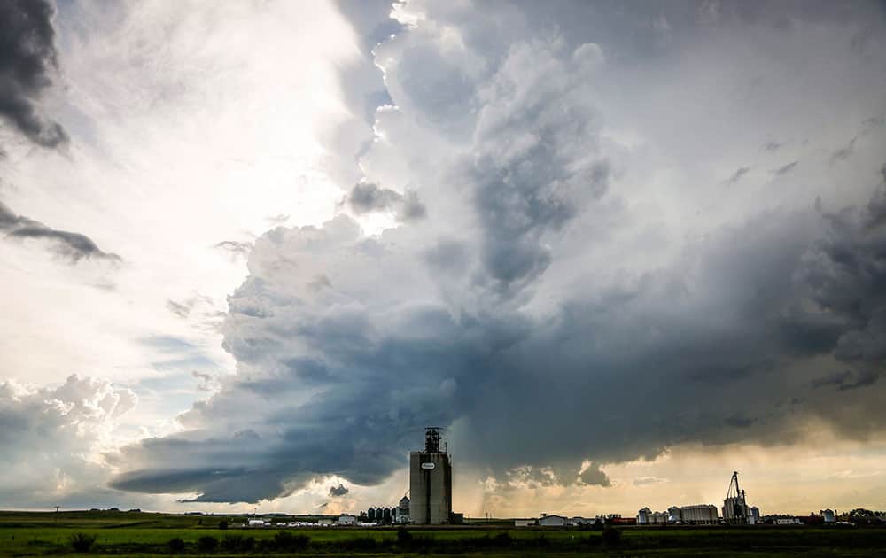 Storm clouds gather over a grain elevator near Carstairs, Alberta.