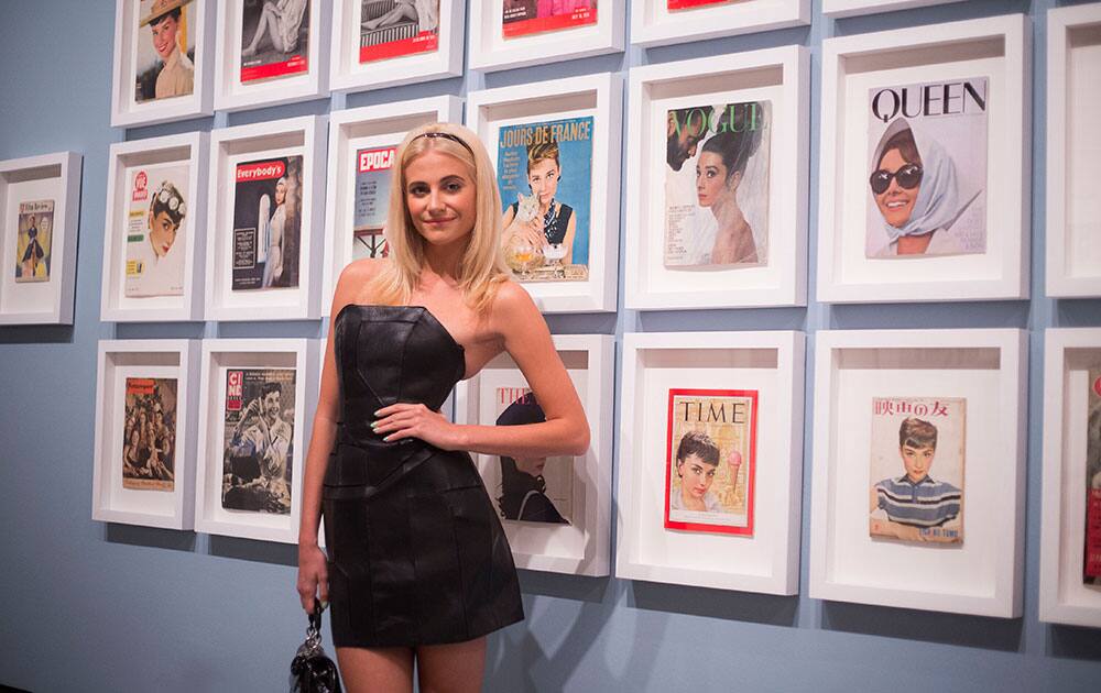 British singer Pixie Lott, who is to appear as Holly Golightly in a stage adaptation of the film, Breakfast at Tiffany's, stands alongside a portrait of actress Audrey Hepburn, at the National Portrait Gallery in London.