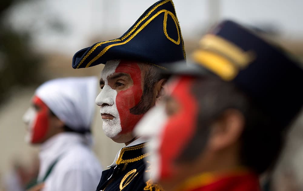 A patient from the Larco Herrera Psychiatric Hospital wears a costumes in the likeness of Peru's Independence hero Don Jose de San Martin during the hospital's Independence Day parade in Lima, Peru.
