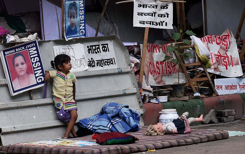 A girl child stands at the protest site near Jantar Mantar in New Delhi.