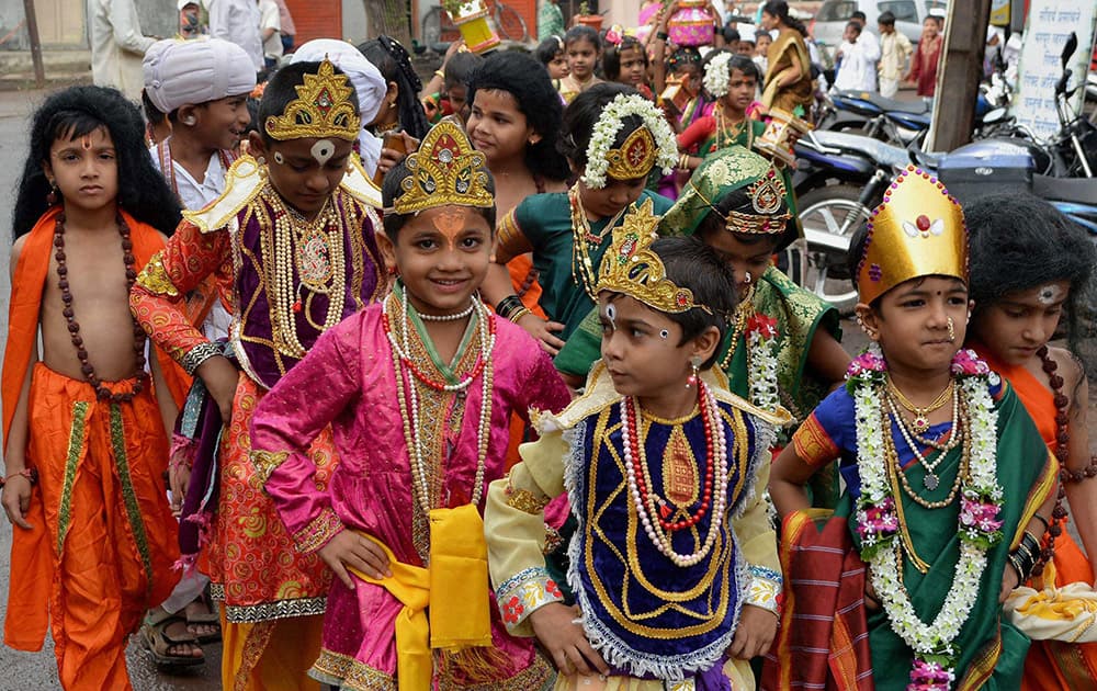 School children dressed up as Lord Vithal participate in the Palkhi procession ahead of the Ashadhi Ekadashi in Karad, Maharashtra.