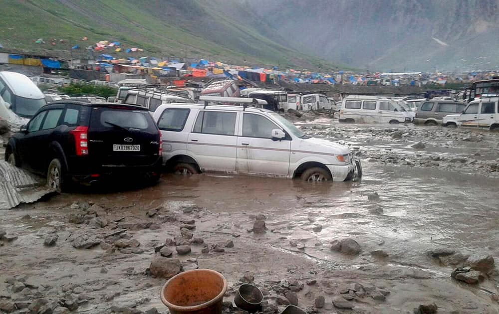 Vehicles stuck in the slush and mud after cloudbursts at Baltal near the base camp of Amarnath Yatra.