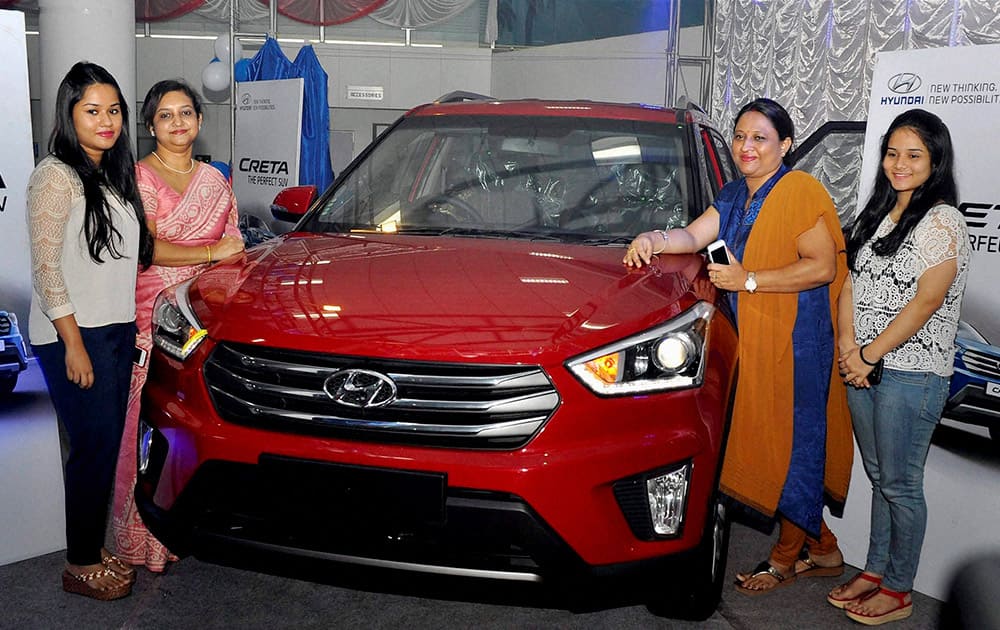 Women pose for photographs after the launch of new Hyundai vehicle Creta in Guwahati.