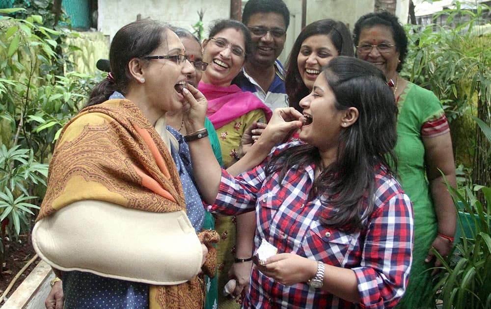 Family members of Ankit Chavan celebrate at their residence in Mumbai, after a trial court discharged Ankit in the Indian Premier League 2013 spot-fixing scandal.