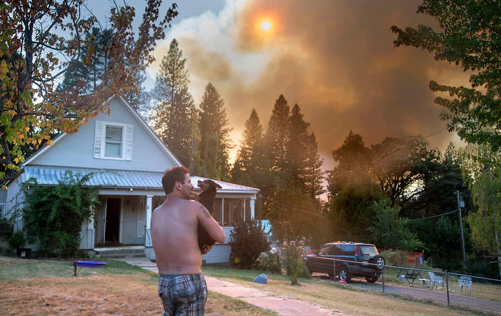 A resident in Dutch Flat, Calif., watches smoke from a wildfire.