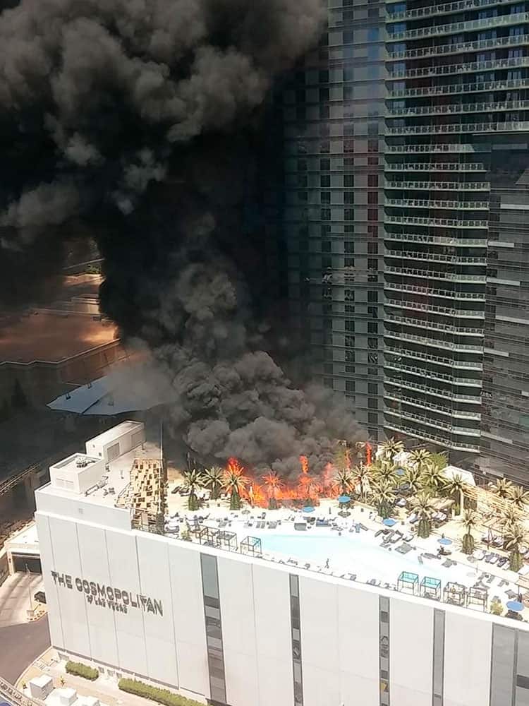Smokes billows from a fire on the outside pool area of the Cosmopolitan Las Vegas hotel-casino, in Las Vegas. 