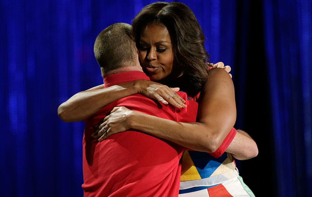First Lady Michelle Obama, right, hugs former Special Olympian Tim Harris during the opening ceremony of the 2015 Special Olympics World Games, in Los Angeles. 