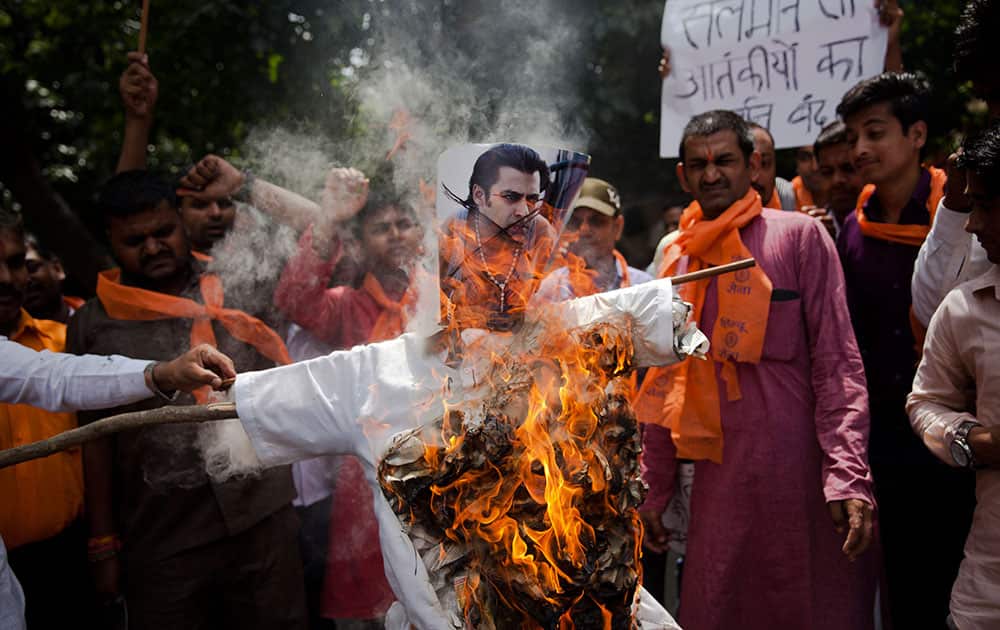 A small group of right wing Hindu activists burn an effigy of Bollywood star Salman Khan in New Delhi.