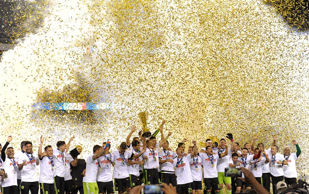 Mexico players celebrate their 3-1 win over Jamaica in the CONCACAF Gold Cup championship soccer match, in Philadelphia. 