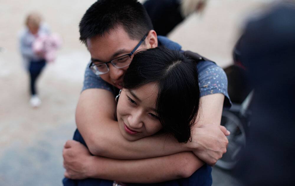 Spectators hug as they wait for the riders to pass during the twenty-first and last stage of the Tour de France cycling race over 109.5 kilometers (68 miles) with start in Sevres and finish in Paris, France.