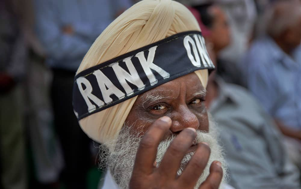 A former Sikh army soldier wears a headband around his turban during a protest in New Delhi, India.