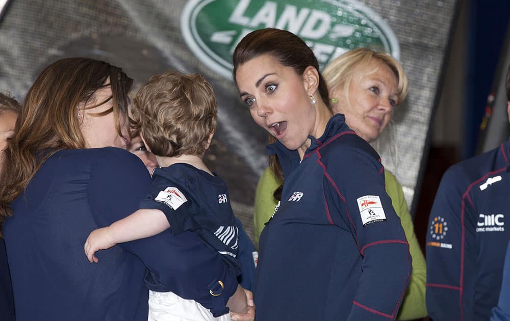 Kate, the Duchess of Cambridge, centre, accompanied by Britain's Prince William, meets family members on a visit to the new BAR, Ben Ainslie Racing team base for the America's Cup World Series, in Portsmouth, England.