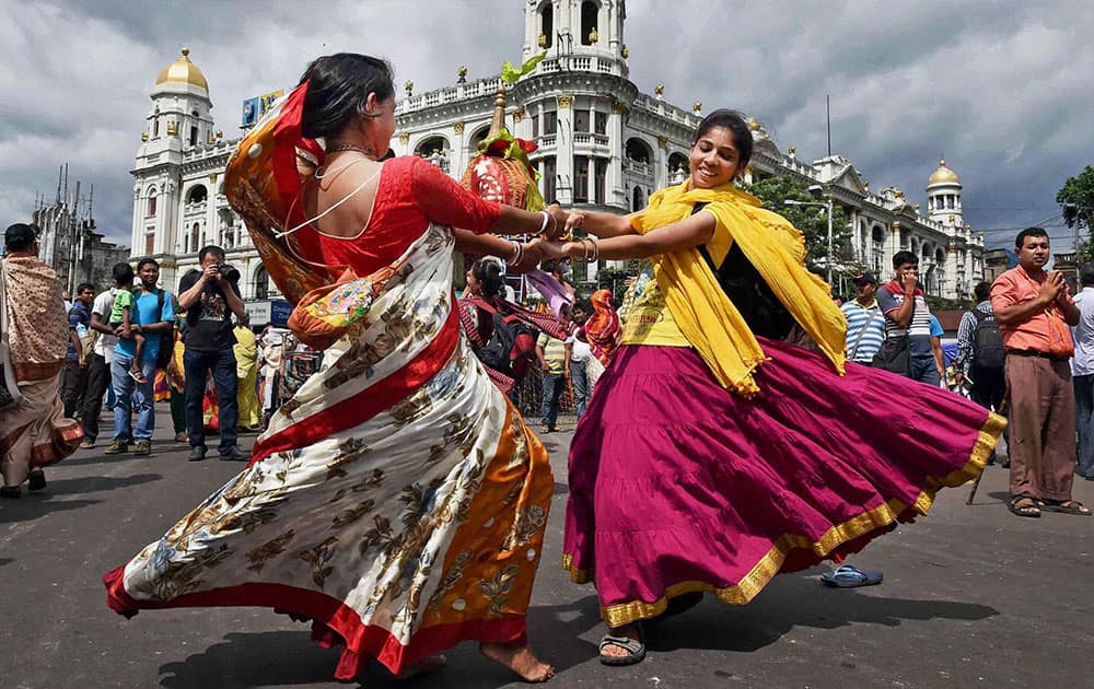 Devotees dance during the ISKCONs Ulta Rath Yatra in Kolkata.