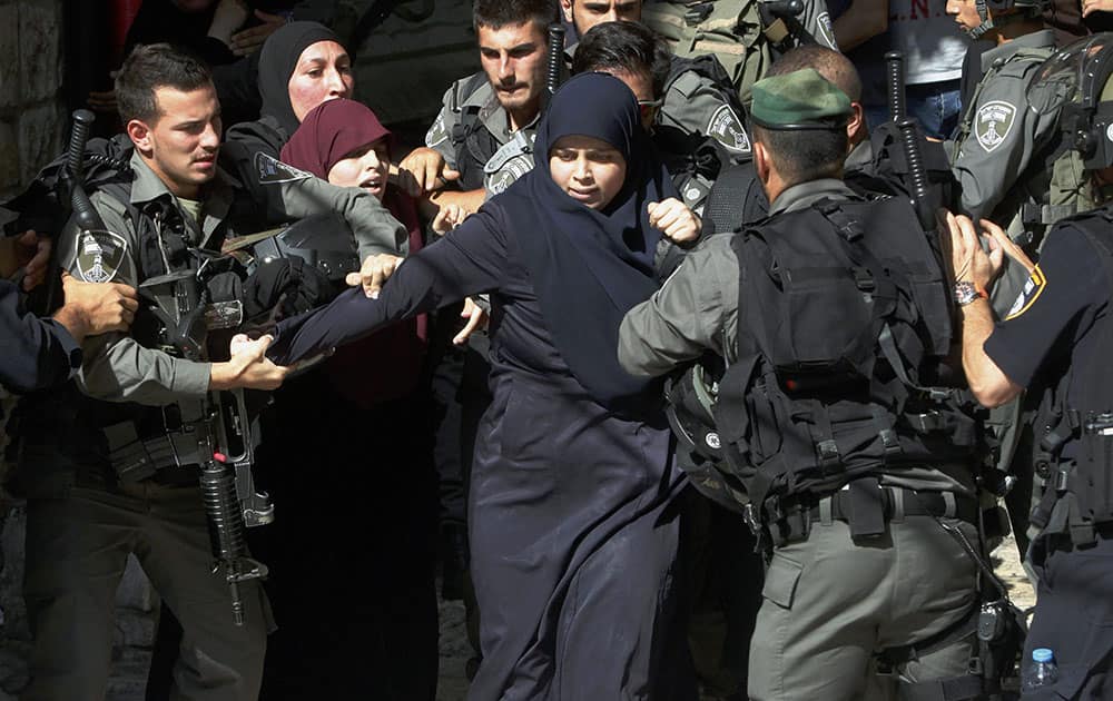 Israeli border police officers scuffle with Palestinian women in the Old City of Jerusalem.