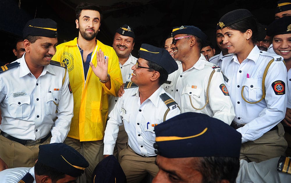 The otherwise tired faces of this bunch of traffic cops, all because of harsh weather, pollution and always-in-a-hurry motorists, wear beaming smiles as they pose with actor Ranbir Kapoor, after receiving raincoats from him at an event in Bandra. -dna