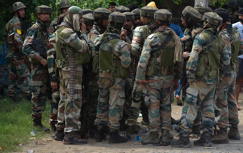 Indian army listen instructions from a higher commander during a fight in the town of Dinanaga, in the northern state of Punjab, India.