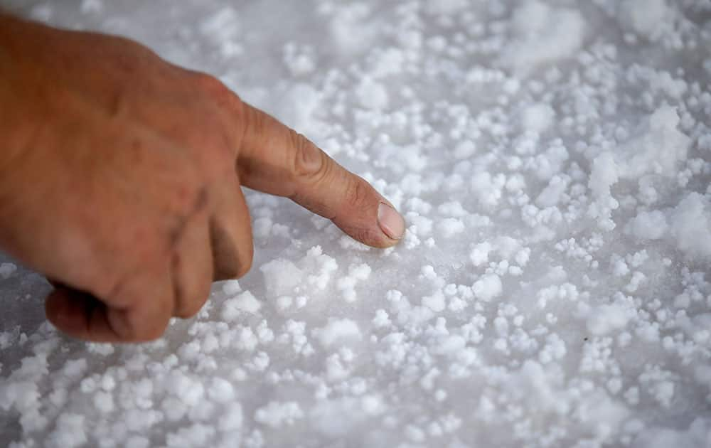 Bill Lattin, the Southern California Timing Association president and Speed Week race director, points to salt on the Bonneville Salt Flats in Utah. 