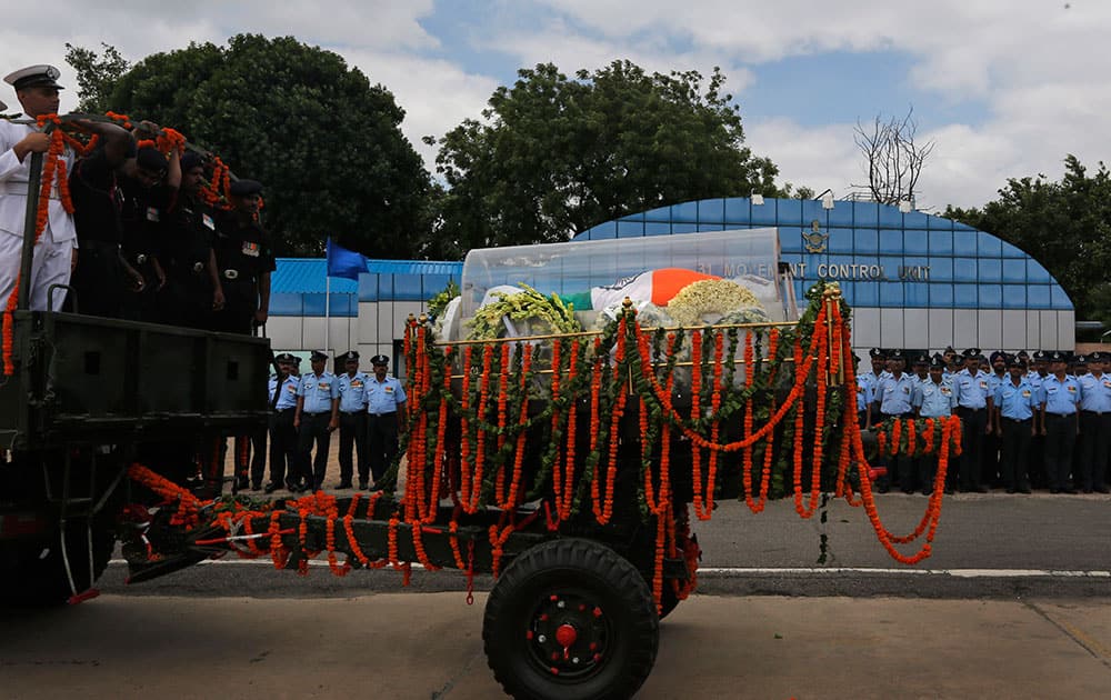 A convoy carries the flag-draped casket of former President A.P.J Abdul Kalam to his residence from Palam airport in New Delhi, India.