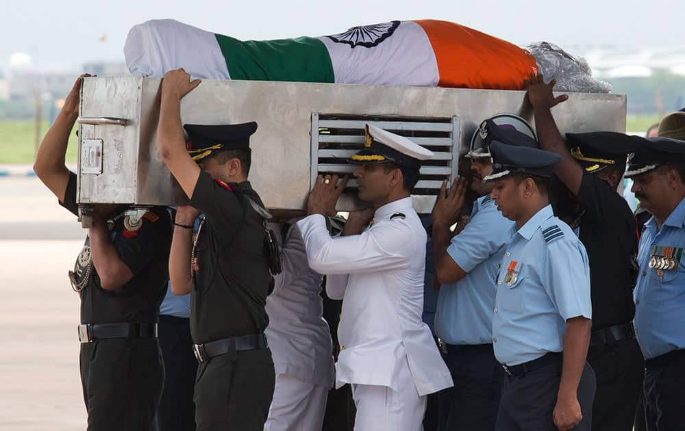 Indian Defense forces carry the flag-draped casket of former President A.P.J. Abdul Kalam after it arrived at Palam airport in New Delhi, India.