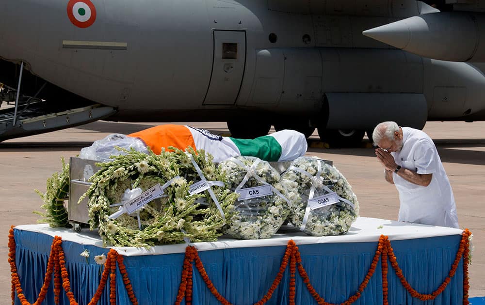 Prime Minister Narendra Modi pays respect after the body of former President A.P.J. Abdul Kalam arrived at the Palam airport in New Delhi, India.