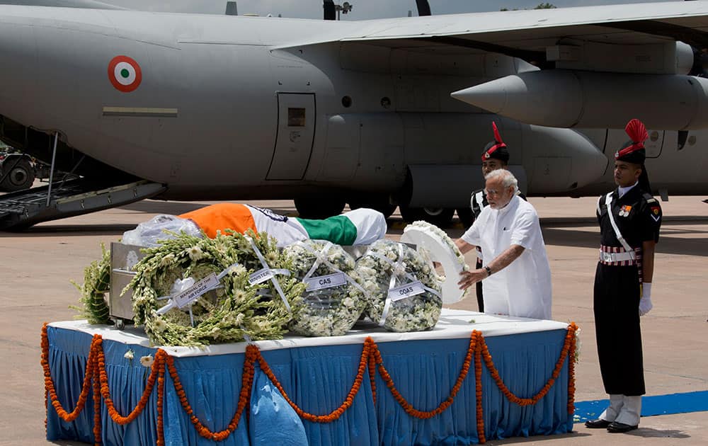 Prime Minister Narendra Modi, second right, places a wreath as he pays tribute to former President A.P.J. Abdul Kalam after his body arrived at the Palam airport in New Delhi, India.