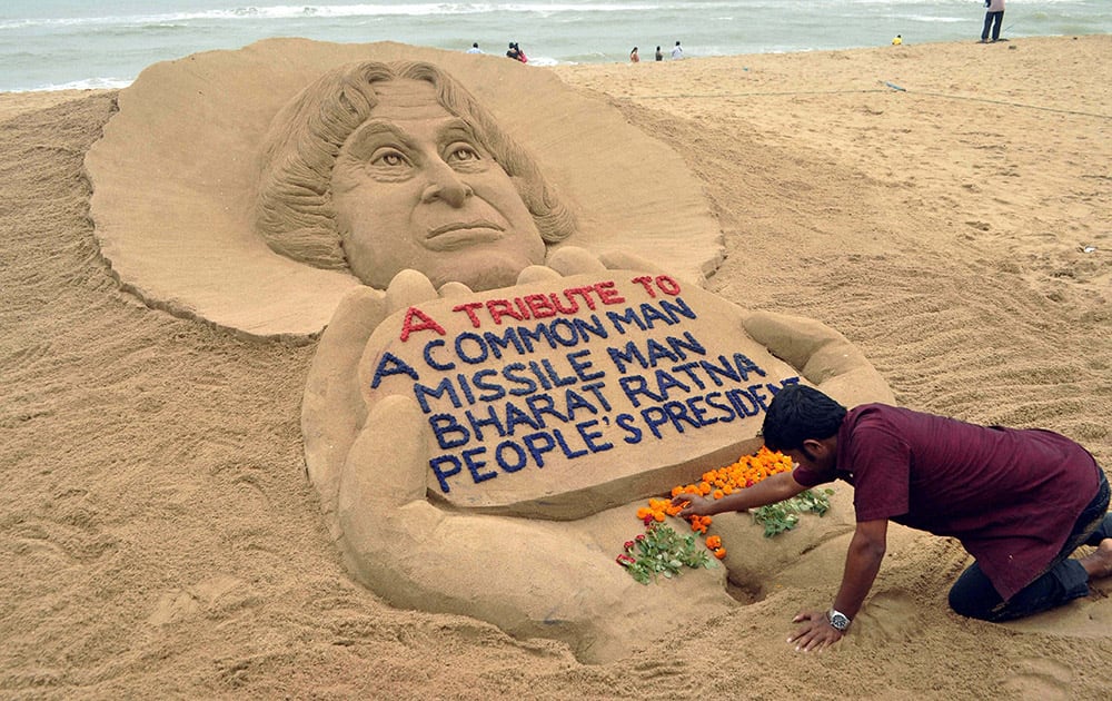 Sand artist Sudarsan Pattnaik creates a sand sculpture to pay tribute to former President APJ Abdul Kalam, at Puri beach in Odisha.