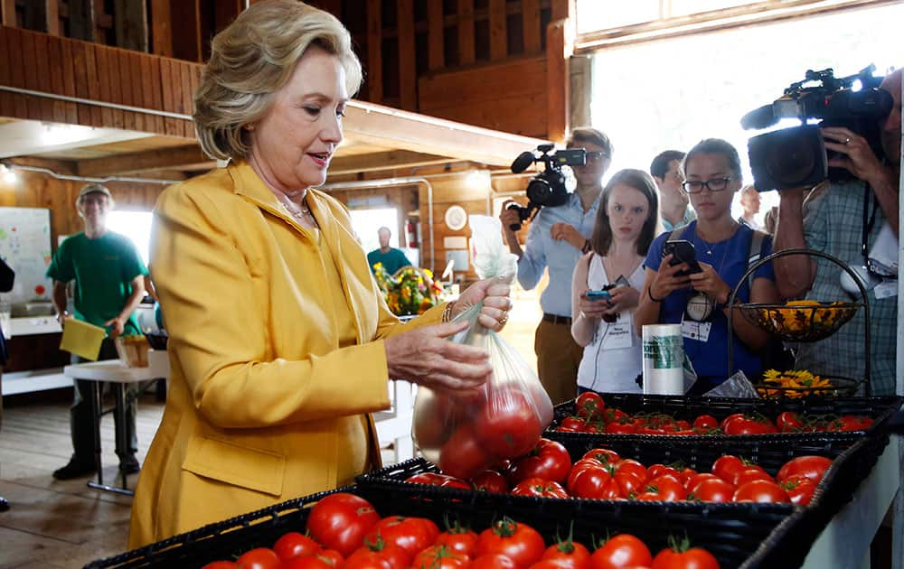 Democratic presidential candidate Hillary Rodham Clinton gets fresh tomatoes at Dimond Hill Farm between campaign stops in Hopkinton, N.H.