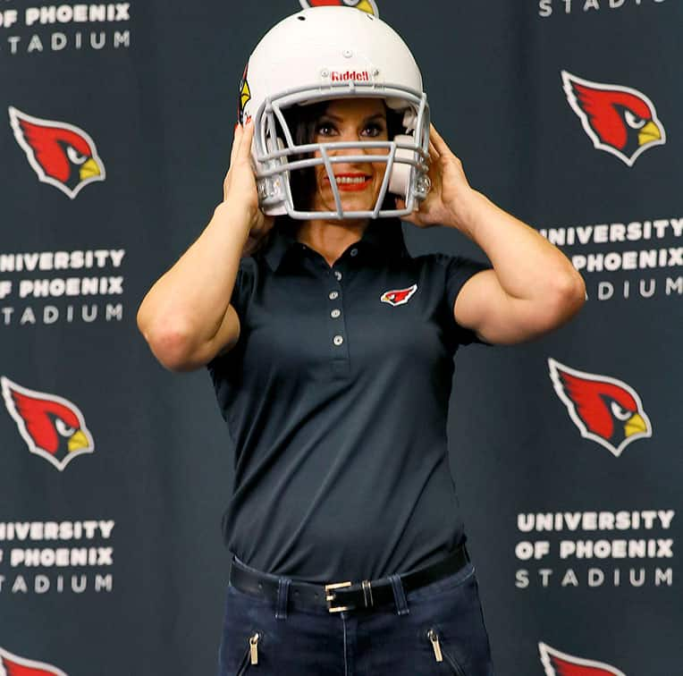 Arizona Cardinals training camp football coach Dr. Jen Welter poses for photographers after being introduced, at the teams' training facility in Tempe, Ariz. 