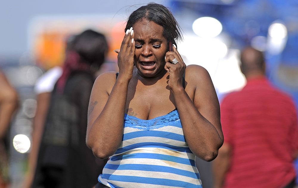 Keisha Hopkins walks away from the scene of deadly church bus crash along Interstate 70 in Greenfield, Ind. Indiana State Police Capt. David Bursten says the bus was traveling from northwestern Indiana when it crashed in eastbound lanes about 20 miles east of Indianapolis.