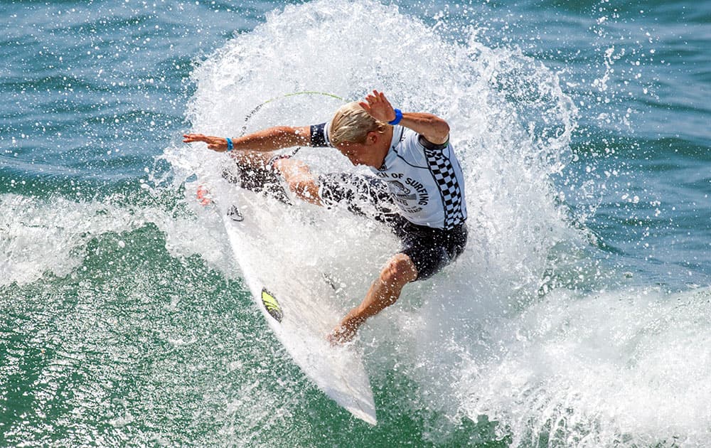 Charles Martin cuts back on a wave during his opening round heat against Brett Simpson at the U.S. Open of Surfing, in Huntington Beach, Calif. 