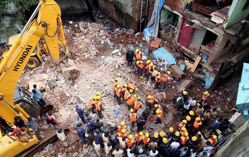 Fire brigade and NDRF personnel rescue a person stuck in the three floor Matru-Chhaya building which collapsed in Thakurli near Thane.