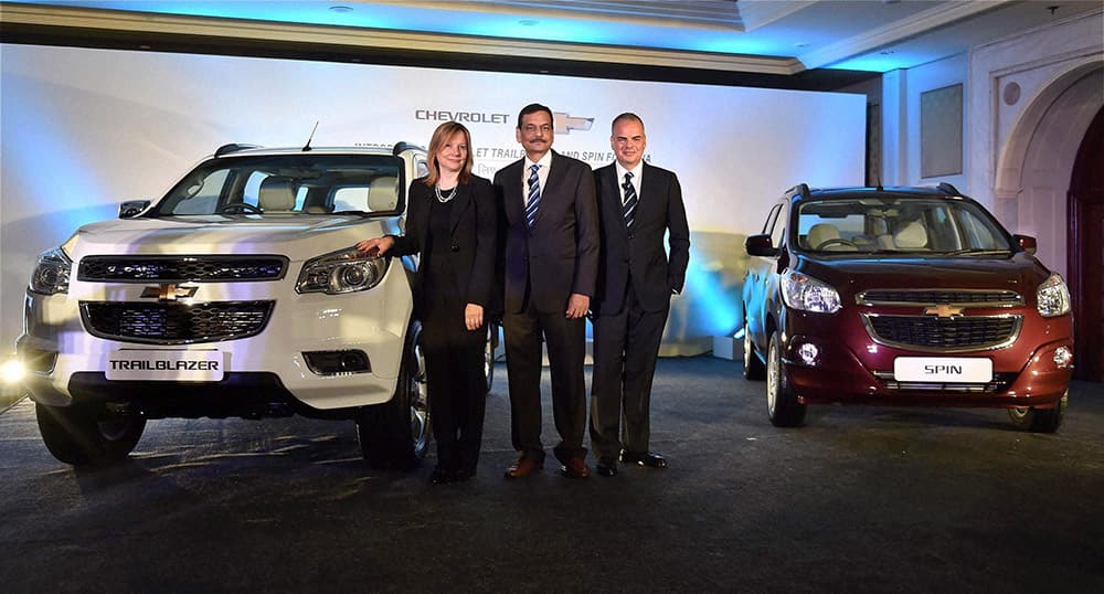 General Motors CEO Mary Barra with GM India President & MD Arvind Saxena and GM International President Stefan Jacoby pose for photographs with upcoming models of Chevrolet cars, in New Delhi.