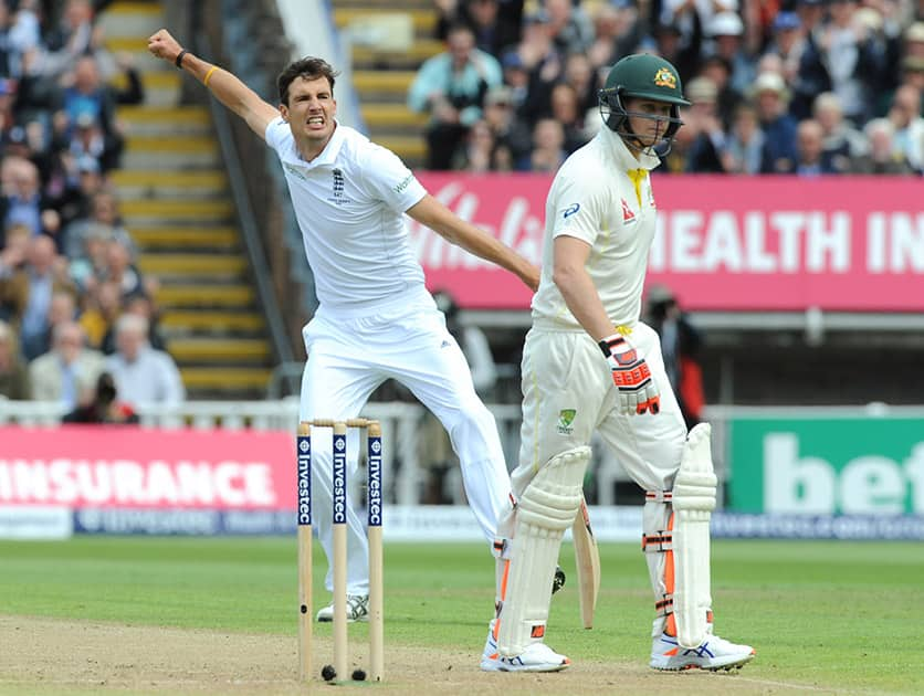 England’s Steven Finn celebrates after bowling Australia’s Steven Smith, caught Alastair Cook for 7 runs during day one of the third Ashes Test cricket match, at Edgbaston, Birmingham, England.